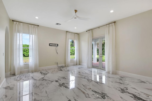 unfurnished room with french doors and ceiling fan