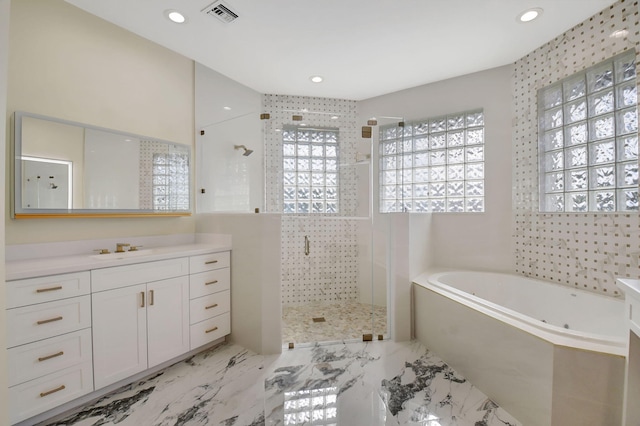 bathroom featuring vanity and separate shower and tub