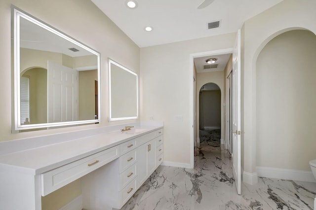 bathroom featuring vanity and toilet