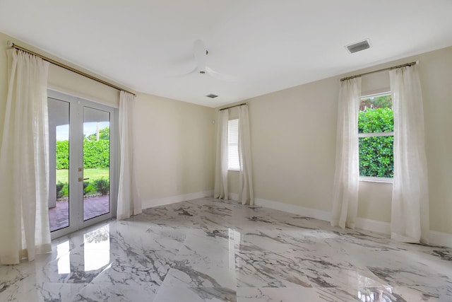 unfurnished room with a wealth of natural light, french doors, and ceiling fan