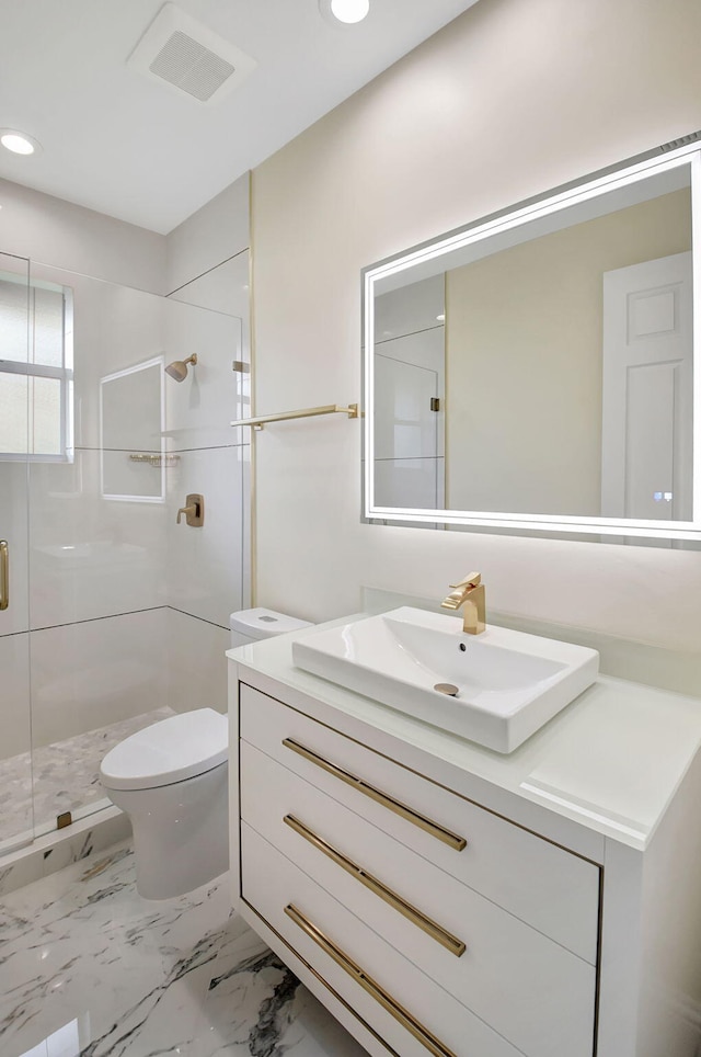 bathroom featuring vanity, toilet, and an enclosed shower