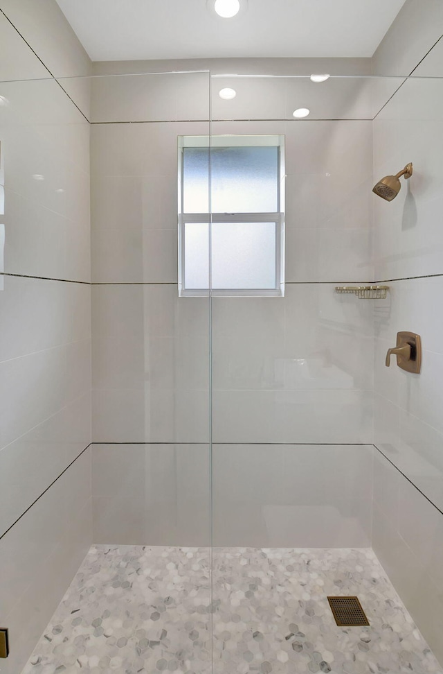 bathroom with a tile shower