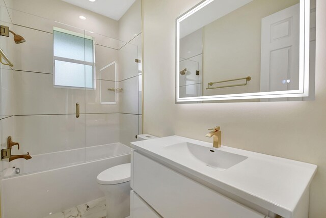 full bathroom featuring bathtub / shower combination, vanity, and toilet