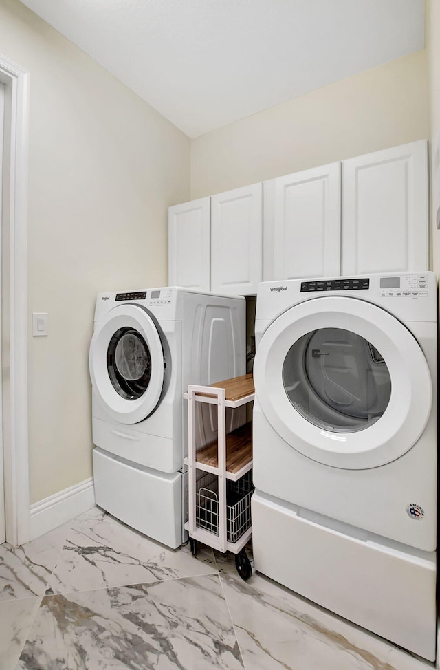 laundry area with cabinets and separate washer and dryer