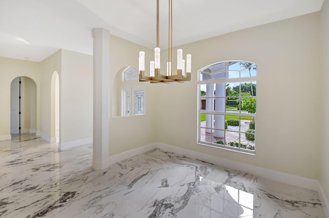 unfurnished dining area with a wealth of natural light and a chandelier