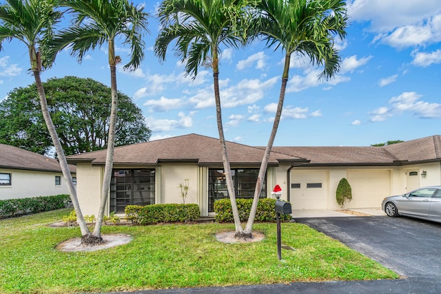 ranch-style house with a front lawn and a garage