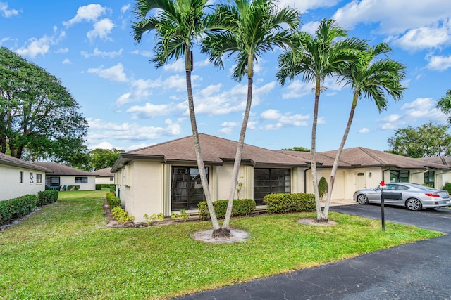 ranch-style house with a front lawn