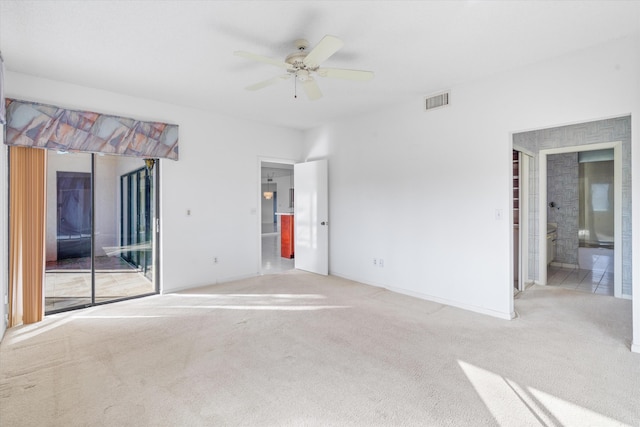 interior space with ceiling fan and light colored carpet