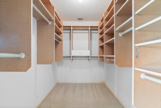 walk in closet with carpet flooring