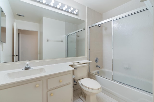 full bathroom with tile patterned flooring, vanity, toilet, and bath / shower combo with glass door