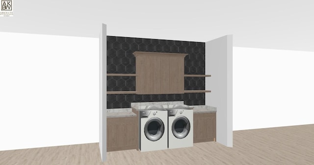 laundry area with washer and clothes dryer, cabinets, and light wood-type flooring