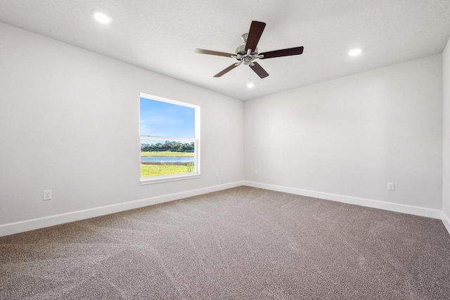 unfurnished room featuring carpet and ceiling fan