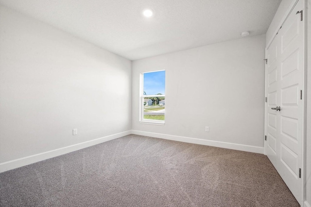 unfurnished bedroom with carpet and a textured ceiling