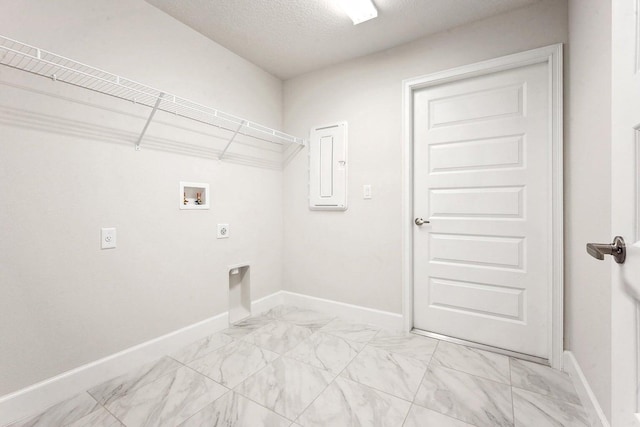 washroom featuring electric dryer hookup, electric panel, a textured ceiling, and hookup for a washing machine