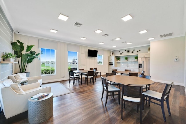 dining space featuring crown molding and dark hardwood / wood-style floors