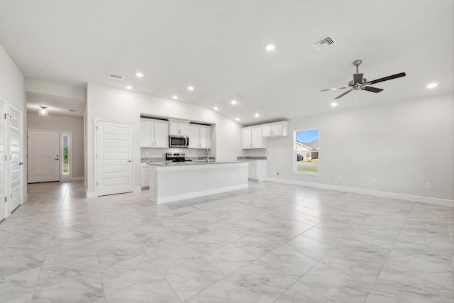 unfurnished living room featuring ceiling fan and vaulted ceiling