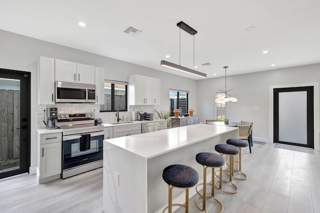 kitchen with white cabinetry, sink, and appliances with stainless steel finishes