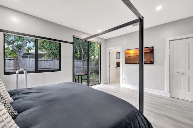 bedroom with a closet and light hardwood / wood-style flooring