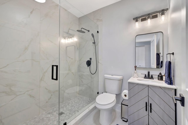 bathroom with vanity, toilet, and a shower with shower door