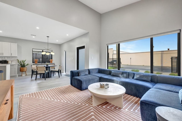 living room featuring carpet flooring and high vaulted ceiling