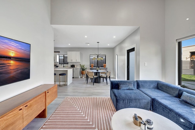 living room with high vaulted ceiling and dark colored carpet