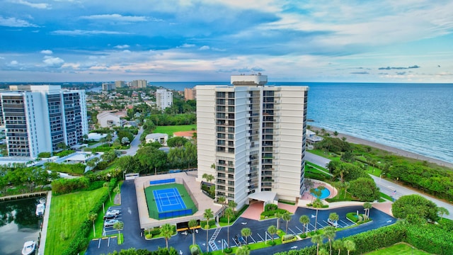 drone / aerial view with a water view and a beach view