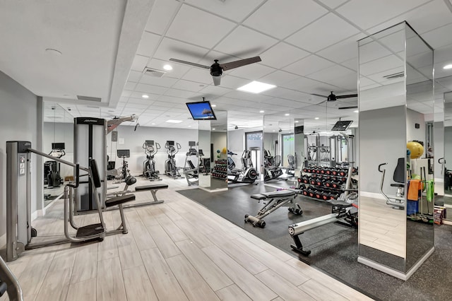 gym with a drop ceiling and ceiling fan