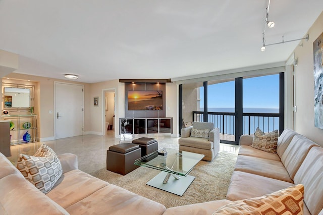 living room with a water view, track lighting, and plenty of natural light