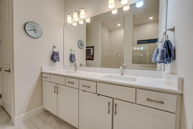 bathroom featuring a tile shower, tile patterned floors, and vanity