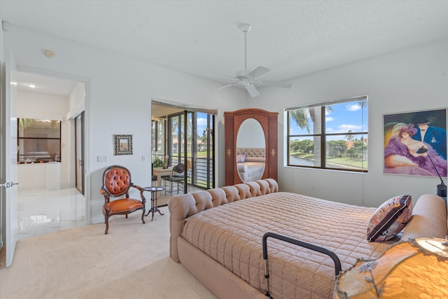 carpeted bedroom with access to exterior, ceiling fan, and a textured ceiling