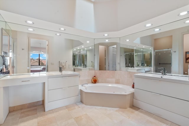 bathroom with shower with separate bathtub and vanity