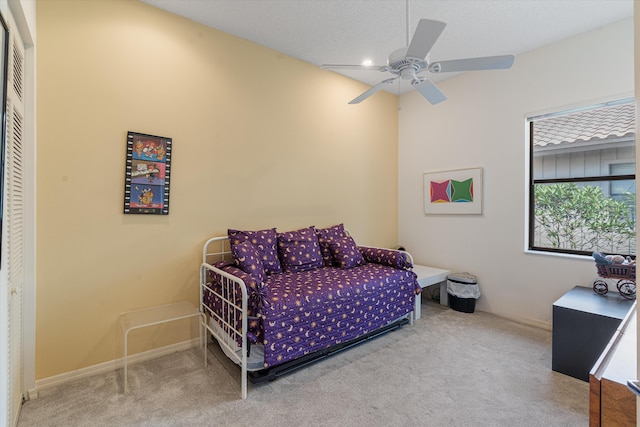 carpeted bedroom with a textured ceiling, a closet, and ceiling fan