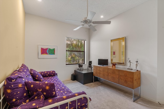 carpeted bedroom with ceiling fan and a textured ceiling