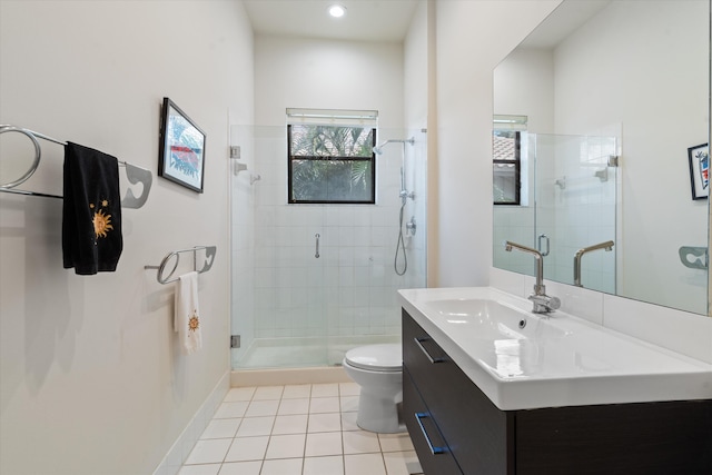 bathroom with tile patterned floors, toilet, vanity, and walk in shower