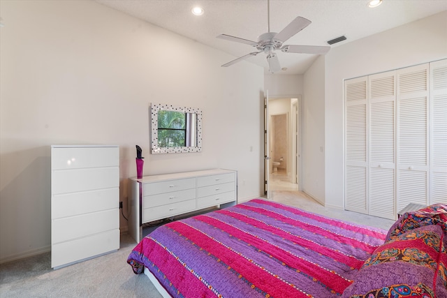 bedroom with ceiling fan, a closet, and light colored carpet