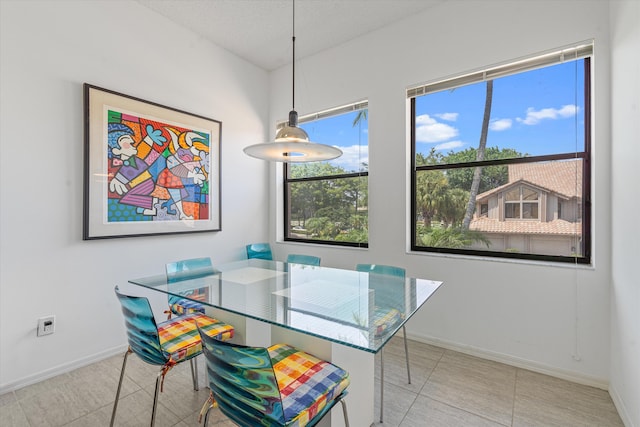 dining area with light tile patterned flooring and a textured ceiling