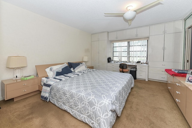 carpeted bedroom featuring a textured ceiling and ceiling fan