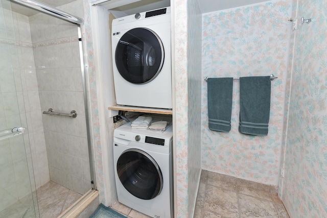 washroom featuring stacked washer and clothes dryer