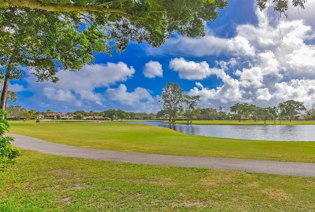 view of home's community featuring a water view and a yard