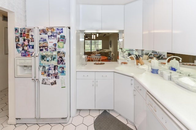 kitchen with white cabinets and white appliances