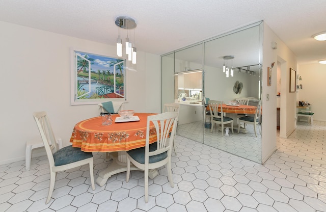 dining space featuring a textured ceiling