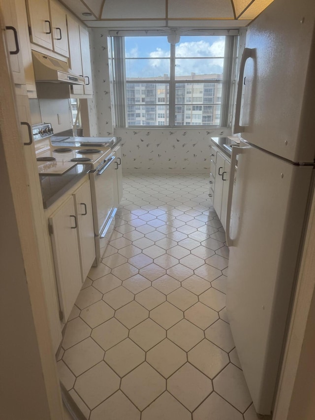 kitchen with white cabinets and white appliances