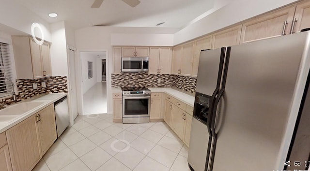 kitchen featuring ceiling fan, tasteful backsplash, light brown cabinetry, appliances with stainless steel finishes, and light tile patterned flooring