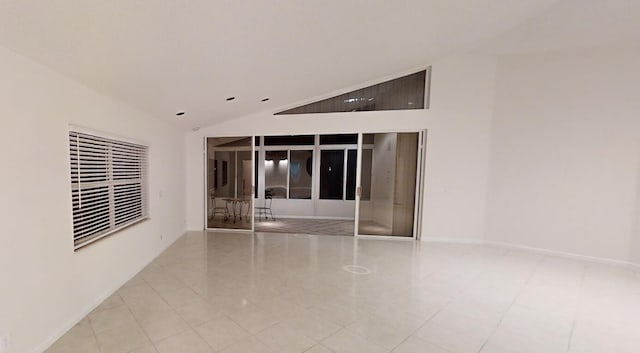 tiled spare room with lofted ceiling