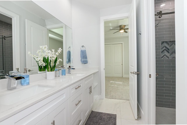 bathroom with vanity, a tile shower, and ceiling fan