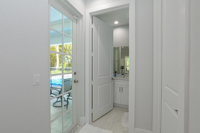 interior space with baseboards and marble finish floor