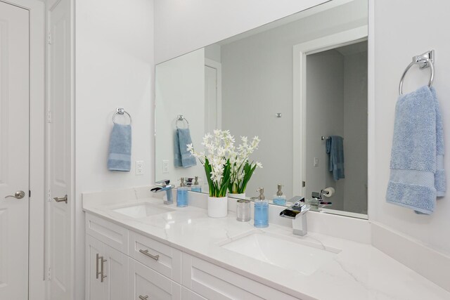 bathroom with double vanity and a sink