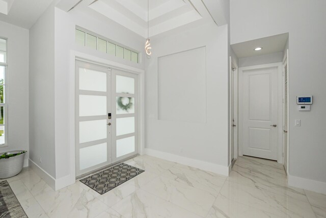 entrance foyer with french doors, baseboards, and marble finish floor