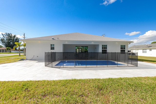 view of swimming pool featuring a patio area and a yard