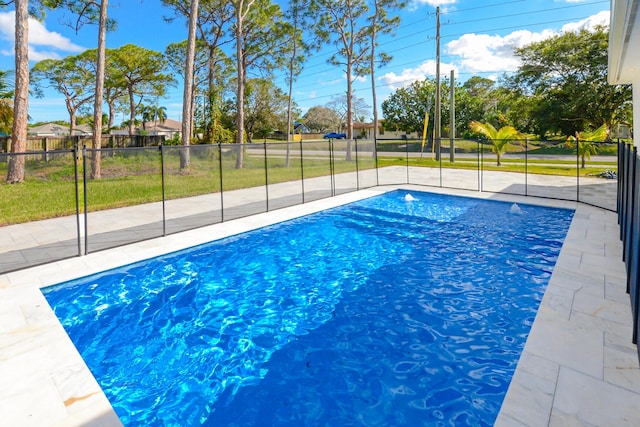 view of swimming pool with a yard